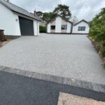 grey resin drive leading to white garage