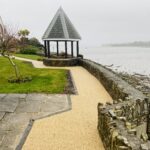 resin pathway next to a wall with a turret to the side